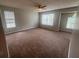 Spacious bedroom with large windows, ceiling fan, and neutral walls and carpeting at 5769 Shadow Creek Dr, Lithonia, GA 30058