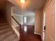 Inviting entryway featuring a staircase and view into the spacious, light-filled living area with beautiful hardwood floors at 5769 Shadow Creek Dr, Lithonia, GA 30058