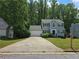 Charming two-story home with gray siding, black shutters, attached garage, and a well-manicured lawn at 5769 Shadow Creek Dr, Lithonia, GA 30058