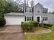 Charming two-story home with a well-maintained lawn, attached garage, and inviting front entrance at 5769 Shadow Creek Dr, Lithonia, GA 30058