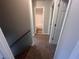 Hallway with carpeted stairs leading to an upper level and a door opening to a bathroom at 5769 Shadow Creek Dr, Lithonia, GA 30058