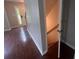 Hallway view with hardwood floors leading to a staircase at 5769 Shadow Creek Dr, Lithonia, GA 30058