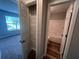 Hallway featuring both a closet for storage and entry to a bathroom, next to a bedroom at 5769 Shadow Creek Dr, Lithonia, GA 30058