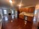 Open-concept kitchen featuring hardwood floors, stainless steel appliances, and a seamless flow to the living area at 5769 Shadow Creek Dr, Lithonia, GA 30058