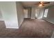 Cozy living room features a ceiling fan, neutral walls and carpet, and natural light at 5769 Shadow Creek Dr, Lithonia, GA 30058