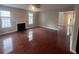 Bright living room featuring a fireplace, windows, and glossy hardwood floors at 5769 Shadow Creek Dr, Lithonia, GA 30058