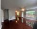 Spacious living room with glossy hardwood floors, fan, and natural light from multiple windows at 5769 Shadow Creek Dr, Lithonia, GA 30058