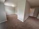 Open living room features neutral paint, carpet, and leads to other rooms at 5769 Shadow Creek Dr, Lithonia, GA 30058