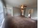 Spacious living room with ceiling fan and large windows bringing in natural light at 5769 Shadow Creek Dr, Lithonia, GA 30058