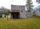 Rear view of the home, featuring a wood deck on the 2nd story at 5769 Shadow Creek Dr, Lithonia, GA 30058