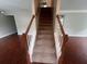Carpeted staircase with wooden railings at 5769 Shadow Creek Dr, Lithonia, GA 30058