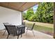A view of the outdoor patio with neutral toned furniture and well-maintained green grass and landscaping at 1355 Hesse Ln, Austell, GA 30106