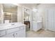 Bright bathroom features double sinks, large mirrors, and a glass-enclosed shower and doorway access to the main bedroom at 1355 Hesse Ln, Austell, GA 30106
