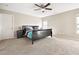 Bedroom boasts a ceiling fan, a large bed, and two windows that let in plenty of natural light at 1355 Hesse Ln, Austell, GA 30106