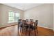 Bright dining room featuring hardwood floors, a modern chandelier, and large windows at 1355 Hesse Ln, Austell, GA 30106