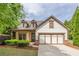 Charming home featuring a two-car garage, manicured lawn, and inviting craftsman architecture at 1355 Hesse Ln, Austell, GA 30106