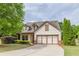 Charming home featuring a two-car garage, manicured lawn, and inviting craftsman architecture at 1355 Hesse Ln, Austell, GA 30106