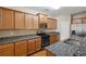 Open kitchen featuring granite countertops, stainless appliances, and light wood cabinetry at 1355 Hesse Ln, Austell, GA 30106