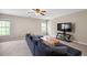 Spacious living room area with cozy seating, ceiling fan, and a TV area with natural light at 1355 Hesse Ln, Austell, GA 30106