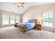 Bright main bedroom featuring vaulted ceilings, carpeted floors, and multiple windows for natural light at 1355 Hesse Ln, Austell, GA 30106