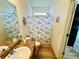 Bathroom featuring a single sink vanity, shower with seashell curtain and wood flooring at 24 Samuel Nw Way, Cartersville, GA 30121