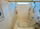 Bathroom features a bathtub with shower and tiled walls with shelves at 24 Samuel Nw Way, Cartersville, GA 30121