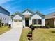 Charming single-story home with a manicured lawn and attached garage under a clear blue sky at 24 Samuel Nw Way, Cartersville, GA 30121