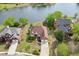 Aerial view of a brick home with mature landscaping, attached garage, and proximity to the lake at 3390 Mill Valley Dr, Dacula, GA 30019