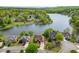 Aerial view showcases a lakefront community with beautiful homes and lush greenery at 3390 Mill Valley Dr, Dacula, GA 30019