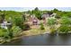 Back of brick home facing a lake, with a sprawling lawn and mature trees at 3390 Mill Valley Dr, Dacula, GA 30019