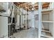 Unfinished basement with water heaters and utility shelving at 3390 Mill Valley Dr, Dacula, GA 30019