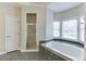 Bathroom showcasing a tub, shower and many windows which offer natural light at 3390 Mill Valley Dr, Dacula, GA 30019