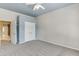 Neutral bedroom featuring carpeted floors, ceiling fan, and double-door closet at 3390 Mill Valley Dr, Dacula, GA 30019