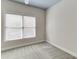 Bedroom featuring a window with blinds and gray carpeting at 3390 Mill Valley Dr, Dacula, GA 30019
