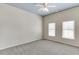 Neutral bedroom featuring carpeted floors, ceiling fan, and two windows with blinds at 3390 Mill Valley Dr, Dacula, GA 30019
