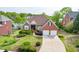 Charming brick home featuring an attached two-car garage, lush lawn, and mature landscaping at 3390 Mill Valley Dr, Dacula, GA 30019