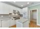 Kitchen showcases stainless steel appliances, white cabinetry, and a kitchen island at 3390 Mill Valley Dr, Dacula, GA 30019