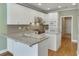 Well-lit kitchen features stainless steel appliances and white cabinetry at 3390 Mill Valley Dr, Dacula, GA 30019