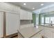 Bright kitchen features an island and an integrated, full-size refrigerator at 3390 Mill Valley Dr, Dacula, GA 30019