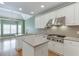Bright kitchen with white cabinets, stainless steel appliances, and an island with lots of workspace at 3390 Mill Valley Dr, Dacula, GA 30019
