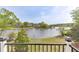 Scenic lake view from a railed balcony, showcasing waterfront living and natural beauty at 3390 Mill Valley Dr, Dacula, GA 30019
