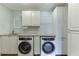 Bright laundry room with modern appliances, white cabinetry, and countertop space at 3390 Mill Valley Dr, Dacula, GA 30019