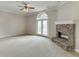 Spacious living room featuring a stone fireplace and a ceiling fan at 3390 Mill Valley Dr, Dacula, GA 30019