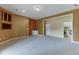 Open-concept living room with carpeted floors, neutral color walls, and a small sink at 3390 Mill Valley Dr, Dacula, GA 30019