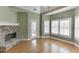 Sunlit living room features a stone fireplace and hardwood floors at 3390 Mill Valley Dr, Dacula, GA 30019