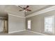 Large main bedroom featuring a tray ceiling and multiple windows at 3390 Mill Valley Dr, Dacula, GA 30019