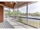 Relaxing screened porch with a ceiling fan, offering serene views of the adjacent lake at 3390 Mill Valley Dr, Dacula, GA 30019