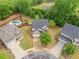 Aerial view of a home with fenced backyard, pool, and playset in a Gathering-friendly neighborhood at 461 Timberleaf Rd, Canton, GA 30115