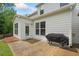 Back patio features a grill, ideal for outdoor cooking and enjoying the serene backyard at 461 Timberleaf Rd, Canton, GA 30115