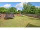 Spacious backyard featuring a trampoline and playset, ideal for Gathering fun and recreation at 461 Timberleaf Rd, Canton, GA 30115